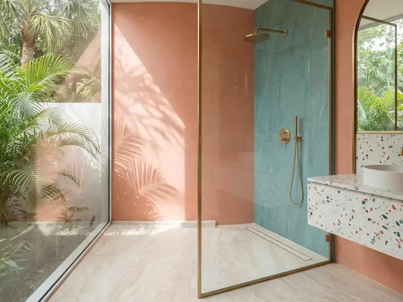 Curbless level entry shower with a linear drain and continuous large format stone floor